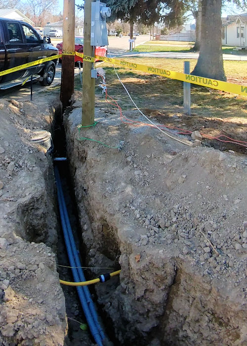 Trench dug with electrical conduit installed